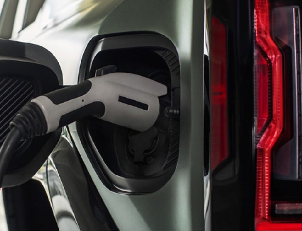 Close up of charging port with charger plugged in on a GMC Hummer EV SUV - Winegardner GMC of Prince Frederick in PRINCE FREDERICK MD